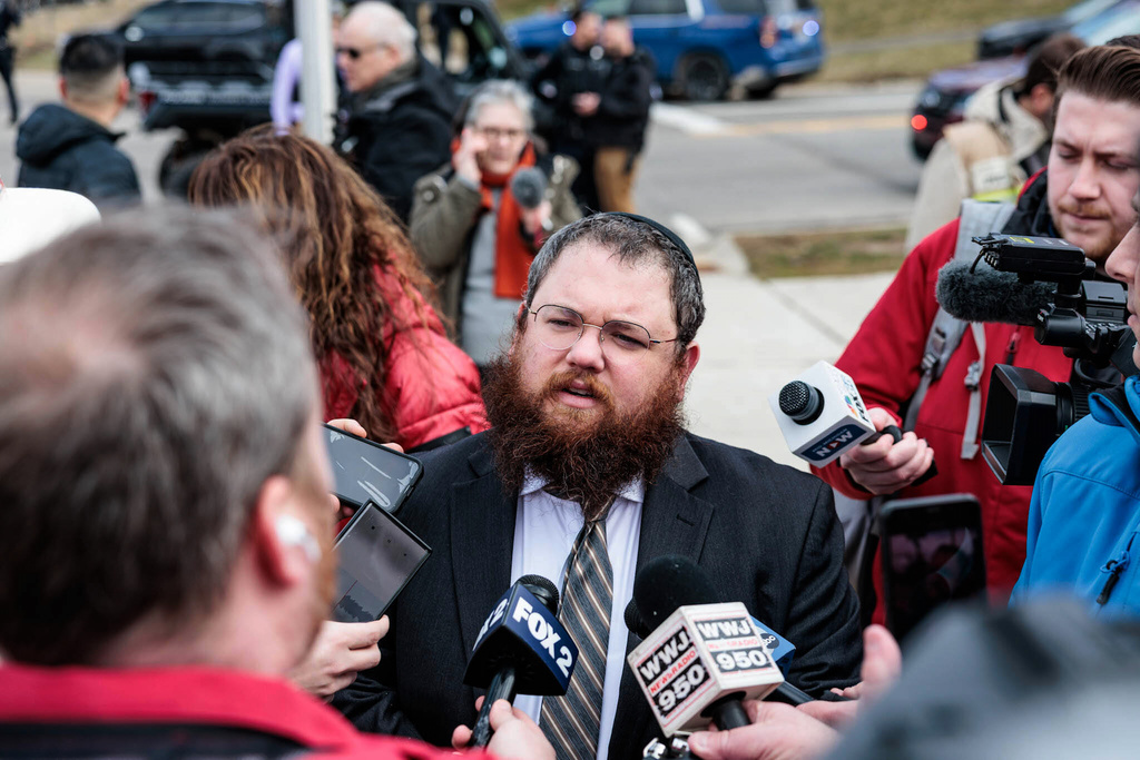 CORRECTS SPELLING OF FIRST NAME TO BENNY - Rabbi Benny Greenwald speaks to media as police respond to the scene of a shooting at Temple Israel in West Bloomfield, Mich., Thursday, March 12, 2026. (Jacob Hamilton/Ann Arbor News via AP)