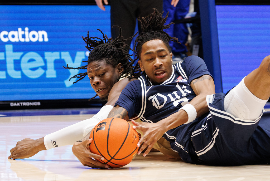 Duke's Isaiah Evans and Boston College's Jayden Hastings, left, dive for a loose ball during the first half of an NCAA college basketball game in Durham, N.C., Tuesday, Feb. 3, 2026. (AP Photo/Ben McKeown)