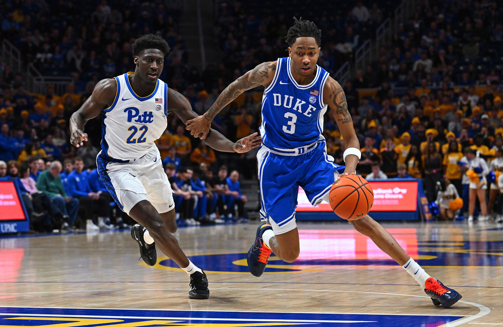 Duke's Isaiah Evans (3) dribbles as Pittsburgh's Barry Dunning Jr. (22) defends during the first half of an NCAA college basketball game in Pittsburgh, Tuesday, Feb. 10, 2026. (AP Photo/Justin Berl)