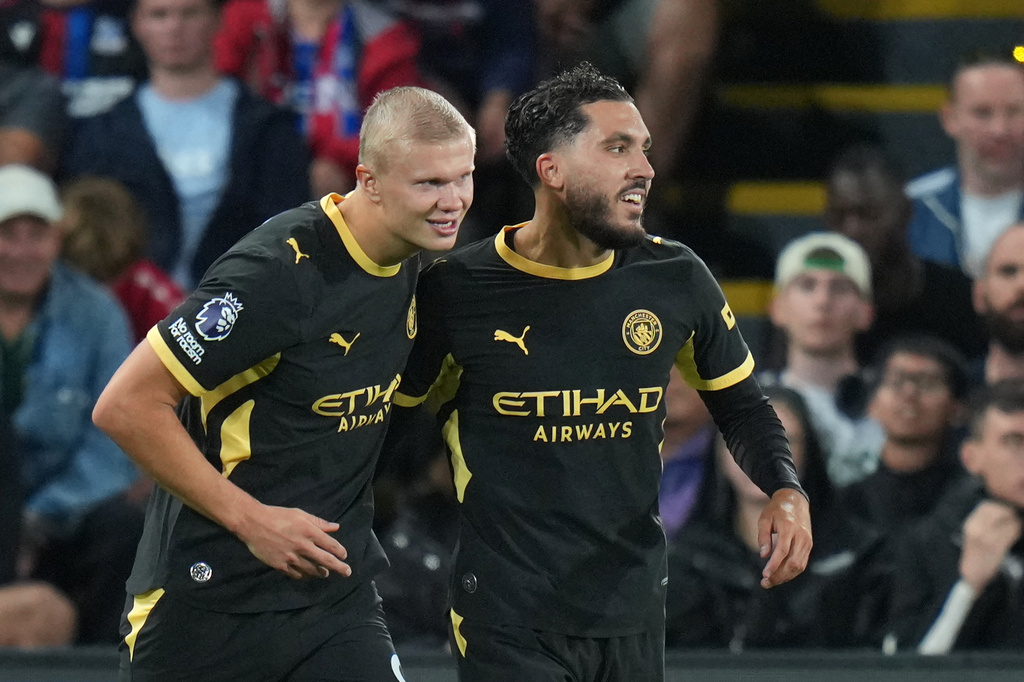 Manchester City's Rayan Cherki, right, celebrates with Erling Haaland after scoring his side's third goal during the English Premier League soccer match between Crystal Palace and Manchester City in London, Friday, Aug. 28, 2026. (AP Photo/Kin Cheung)