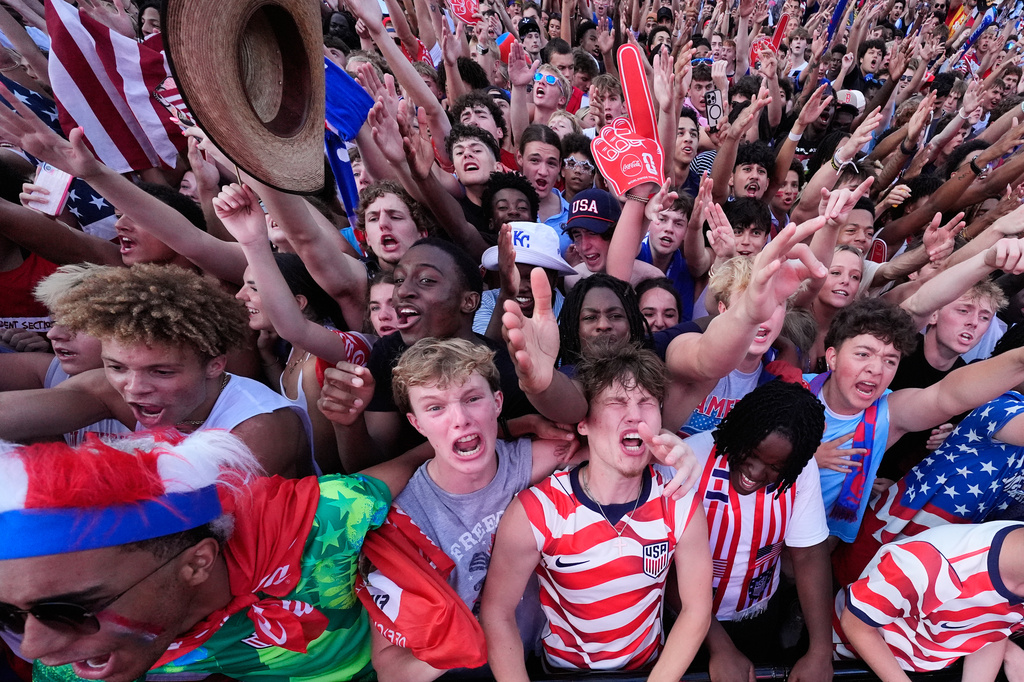 Fans cheer during a watch party for a World Cup soccer match between the United States and Belgium at the KC Live! entertainment district Monday, July 6, 2026, in Kansas City, Mo. (AP Photo/Charlie Riedel)
