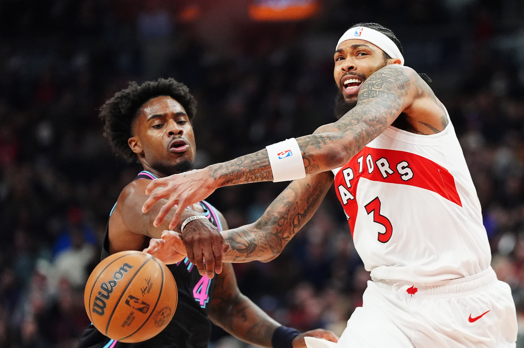 Toronto Raptors' Brandon Ingram (3) is fouled by Miami Heat's Davion Mitchell (45) duringthe first half of an NBA basketball game in Toronto, Tuesday, April 7, 2026. (Frank Gunn/The Canadian Press via AP)