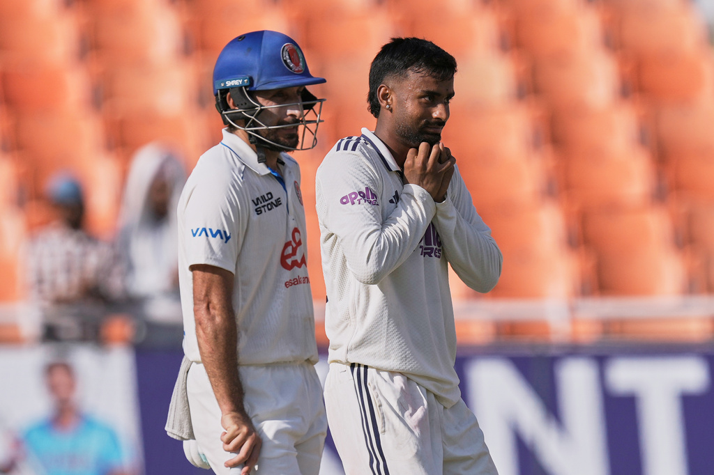 Afghanistan's Rahmat Shah, left, looks on as India's Manav Suthar takes the catch to dismiss Afghanistan's Afsar Zazai off his own bowling on day two of the cricket test match between Afghanistan and India in New Chandigarh, India, Sunday, June 7, 2026. (AP Photo/Ashwini Bhatia)