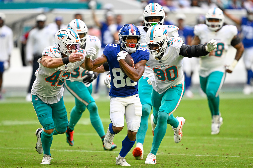 New York Giants wide receiver Calvin Austin III (82) runs the ball during the first half of a preseason NFL football game against the Miami Dolphins, Saturday, Aug. 22, 2026, in Miami Gardens, Fla. (AP Photo/Doug Murray)
