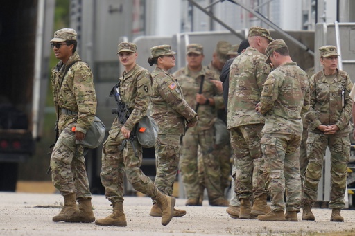 Military personnel in uniform, with the Texas National Guard patch on, are seen at the U.S. Army Reserve Center, Tuesday, Oct. 7, 2025, in Elwood, Ill., a suburb of Chicago. (AP Photo/Erin Hooley) Military personnel in uniform, with the Texas National Guard patch on, are seen at the U.S. Army Reserve Center, Tuesday, Oct. 7, 2025, in Elwood, Ill., a suburb of Chicago. (AP Photo/Erin Hooley)