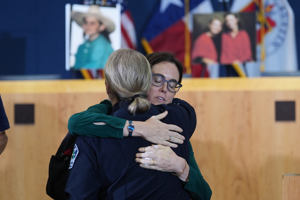 Sonora Thomas, sister of victim Eliza Thomas, right, is hugs Austin Police Chief Lisa Davis following a news conference regarding a breakthrough in the 1991 I Can't Believe It's Yogurt murder case, Monday, Sept. 29, 2025, in Austin, Texas. (AP Photo/Eric Gay)
