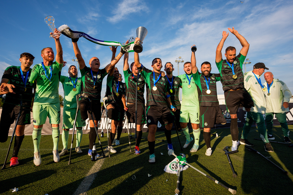 Maccabi Haifa's players celebrate with the trophy during the medal ceremony at the end of the amputee soccer inaugural EAFF Conference League in Bucharest, Romania, Friday, Sept. 25, 2026. (AP Photo/Andreea Alexandru)