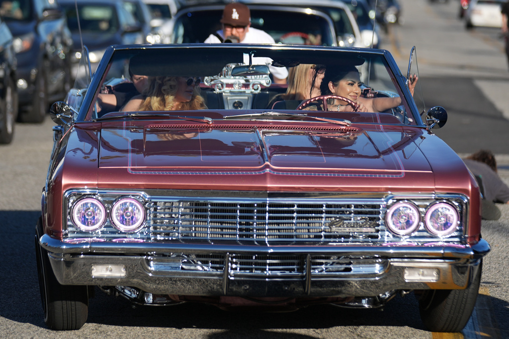 Sandy Avila, right, drives her 1966 Chevy Impala SS at the 6th Annual Lady Lowrider Cruise Night in celebration of International Women's Day in Pasadena, Calif., on Sunday, March 8, 2026. (AP Photo/Damian Dovarganes)