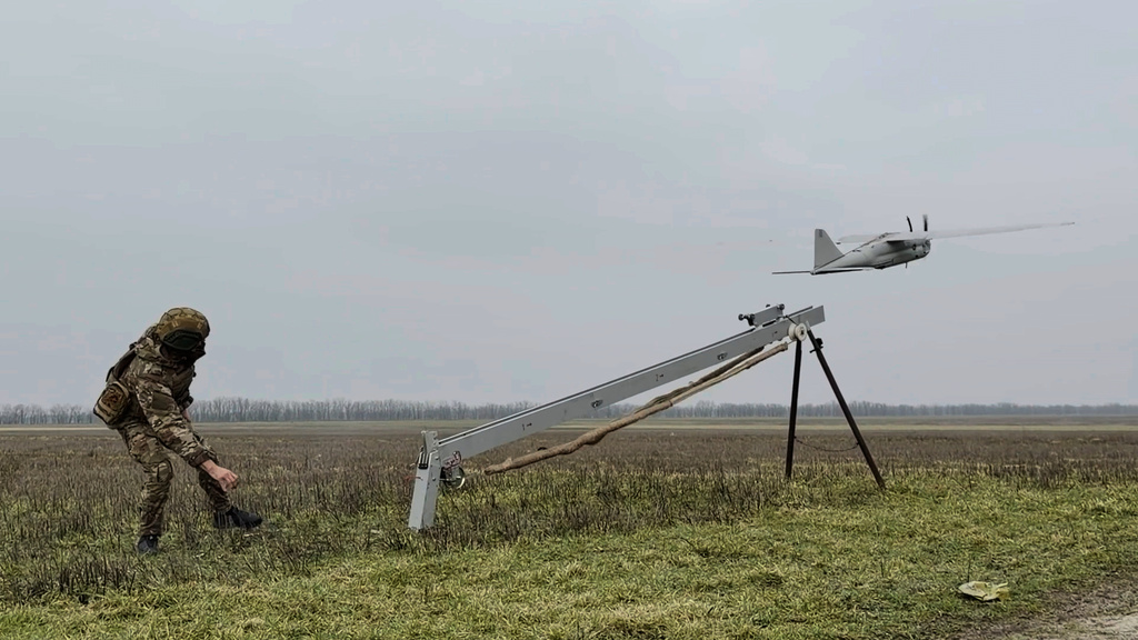 In this image made from video provided by Russian Defense Ministry Press Service on Sunday, Feb. 15, 2026, shows a Russian serviceman launches an Orlan-10 reconnaissance drone tfor an action in an undisclosed location in Ukraine. (Russian Defense Ministry Press Service via AP)