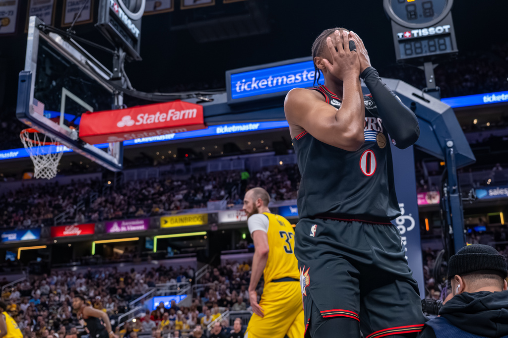 Philadelphia 76ers guard Tyrese Maxey (0) reacts after missing a shot during the first half of an NBA basketball game against the Indiana Pacers in Indianapolis, Friday, April 10, 2026. (AP Photo/Doug McSchooler)