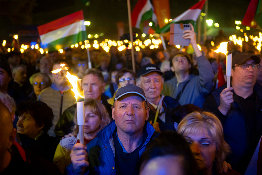 Supporters of prime minister Viktor Orbán listen during a countryside campaign tour in Kaposvár, Hungary, Monday, March 16, 2026 ahead of April 12 parliamentary election. (AP Photo/Denes Erdos)