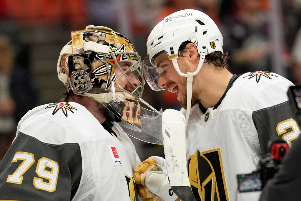 Vegas Golden Knights goaltender Carter Hart, left, and center Brett Howden congratulate each other after the Golden Knights defeated the Anaheim Ducks in Game 6 of a second-round NHL hockey Stanley Cup playoff series Thursday, May 14, 2026, in Anaheim, Calif. (AP Photo/Mark J. Terrill)