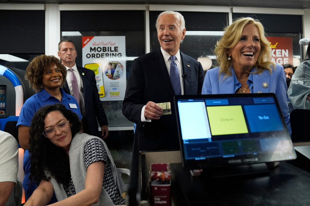 FILE - President Joe Biden, center, and first lady Jill Biden, right, pay for a purchase as they greet supporters at a Waffle House in Marietta, Ga., June 28, 2024, following a presidential debate in Atlanta. (AP Photo/Evan Vucci, File)