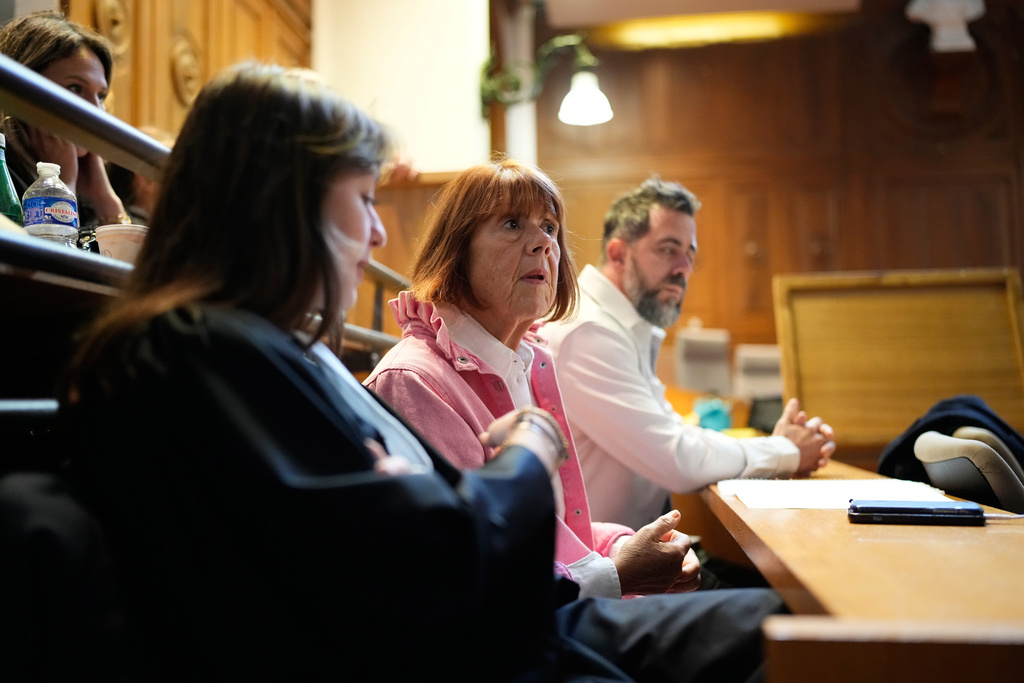 Gisele Pelicot, center, sits in the courtroom during the appeals trial in the case of a man challenging his conviction, less than a year after the landmark verdict in a drugging and rape trial that shook France Thursday, Oct. 9, 2025 in Nimes, southern France. (AP Photo/Lewis Joly)