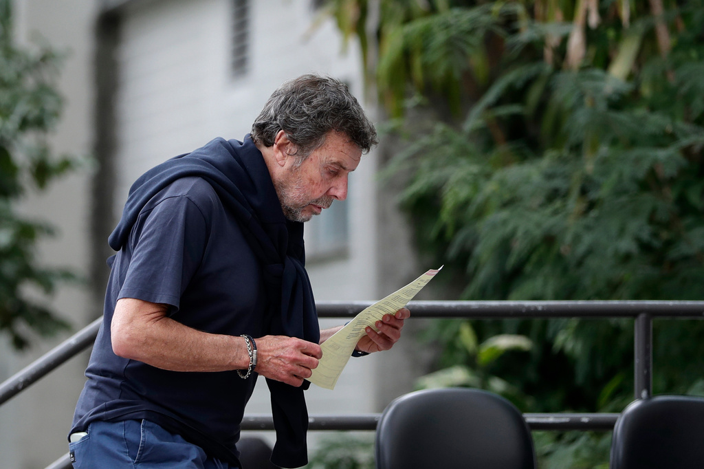 Oscar Vignale, the father of Argentine filmmaker Lucas Vignale, arrives at the Medical Examiner's Office to claim the body of his son who died alongside others when two helicopters collided in midair and crashed in Rio de Janeiro, Brazil, Monday, June 15, 2026. (AP Photo/Bruna Prado)