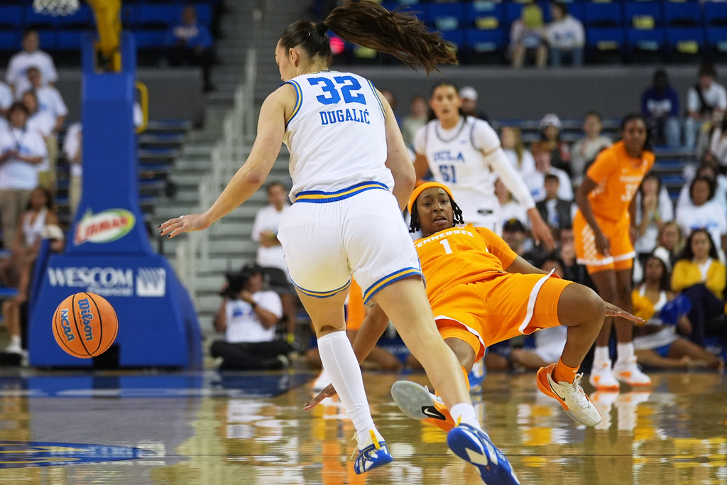 UCLA forward Angela Dugalic (32) takes the ball from Tennessee guard Nya Robertson (1) during the first half of an NCAA college basketball game in Los Angeles, Sunday, Nov. 30, 2025. (AP Photo/Damian Dovarganes)