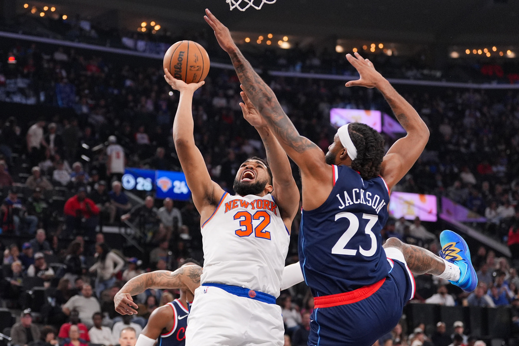 New York Knicks center Karl-Anthony Towns (32) is fouled by Los Angeles Clippers forward Isaiah Jackson (23) during the first half of an NBA basketball game Monday, March 9, 2026, in Inglewood, Calif. (AP Photo/Jae C. Hong)
