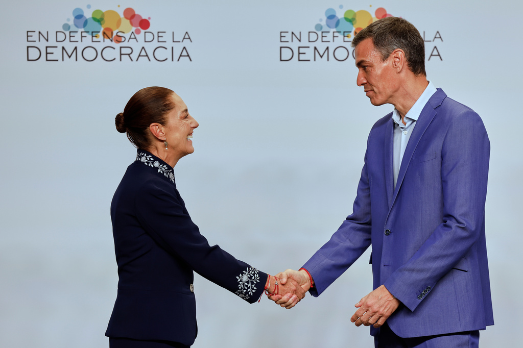 Spain's Prime Minister Pedro Sanchez, right, greets Mexican President Claudia Sheinbaum at the Meeting in Defence of Democracy summit in Barcelona, Spain, Saturday, April 18, 2026. (AP Photo/Joan Monfort)