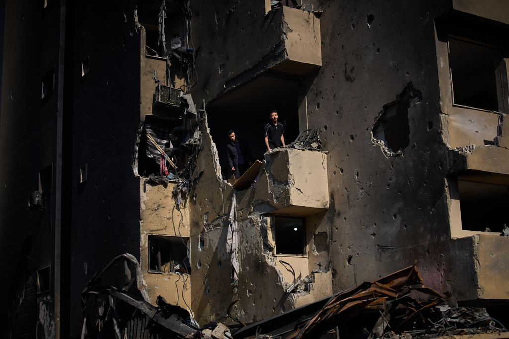 Men inspect the damage to their home destroyed in an Israeli airstrike a day earlier in Beirut, Lebanon, Thursday, April 9, 2026. (AP Photo/Emilio Morenatti)