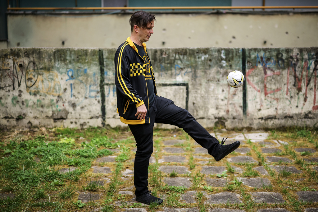 Vedran Mujagic, a member of Bosnian band Dubioza kolektiv, plays with a ball at a soccer playground where the video for the song "I Am From Bosnia, Take Me to America" was filmed, in Sarajevo, Bosnia, Thursday, June 11, 2026. (AP Photo/Armin Durgut)