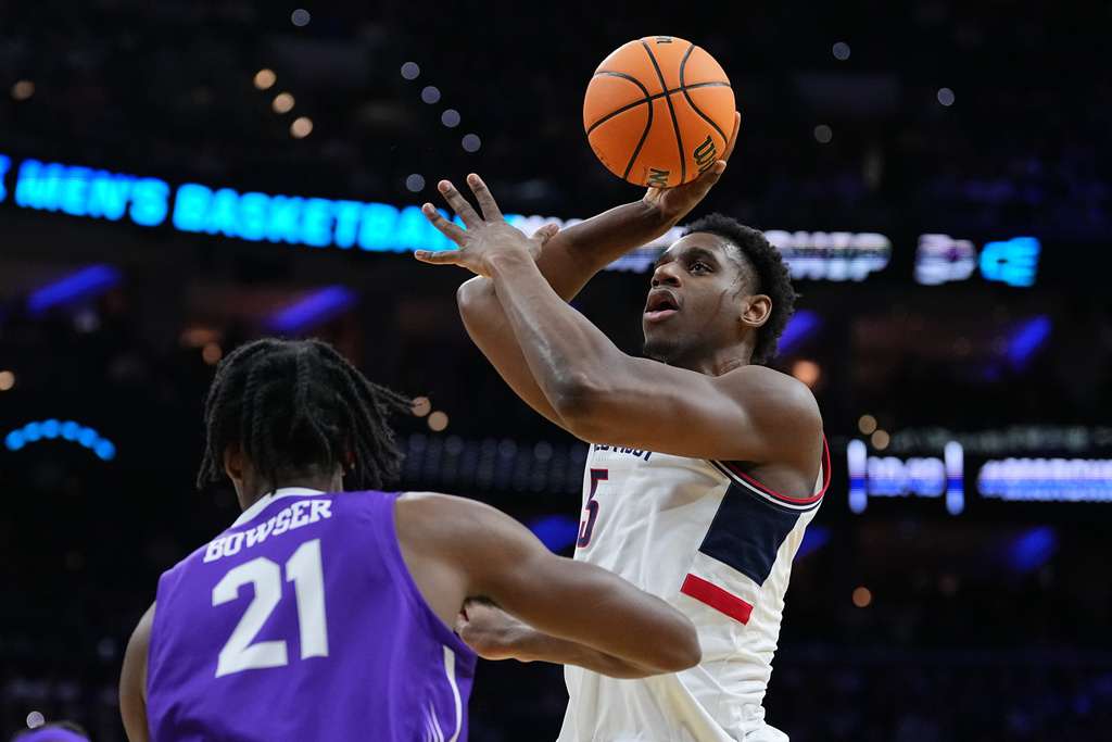 UConn's Tarris Reed Jr., right, goes up for a shot against Furman's Cooper Bowser during the first half in the first round of the NCAA college basketball tournament, Friday, March 20, 2026, in Philadelphia. (AP Photo/Matt Rourke)