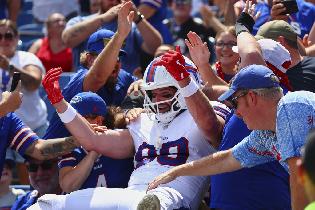 Buffalo Bills' Dawson Knox (88) celebrates with fans after scoring a touchdown during the first half of an NFL preseason football game against the New York Giants Saturday, Aug. 9, 2025, in Orchard Park, N.Y. (AP Photo/Jeffrey T. Barnes)