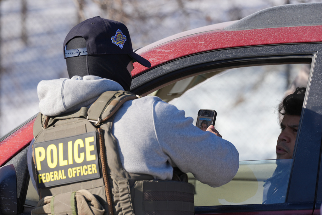 ADDS REFERECE TO FACIAL RECOGNITION APP - A federal agent uses a facial recognition app during a traffic stop on a person on Tuesday, Jan. 27, 2026, in Minneapolis. (AP Photo/Adam Gray)