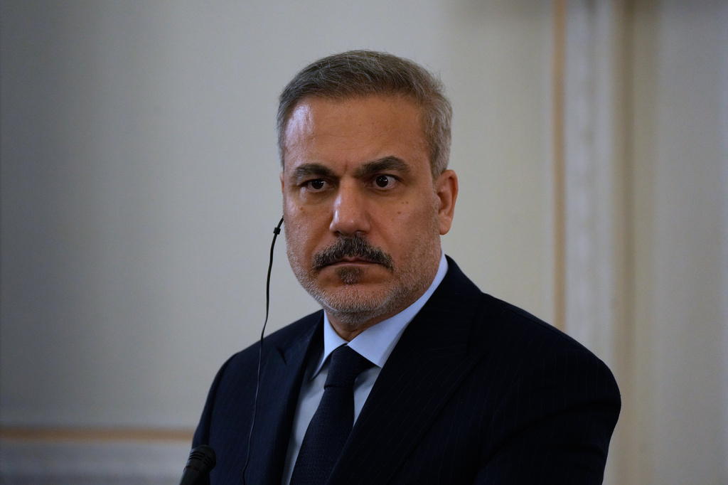 Turkish Foreign Minister Hakan Fidan listens to the translation in a joint news briefing with his Iranian counterpart Abbas Araghchi after their meeting in Tehran, Iran, Sunday, Nov. 30, 2025. (AP Photo/Vahid Salemi)