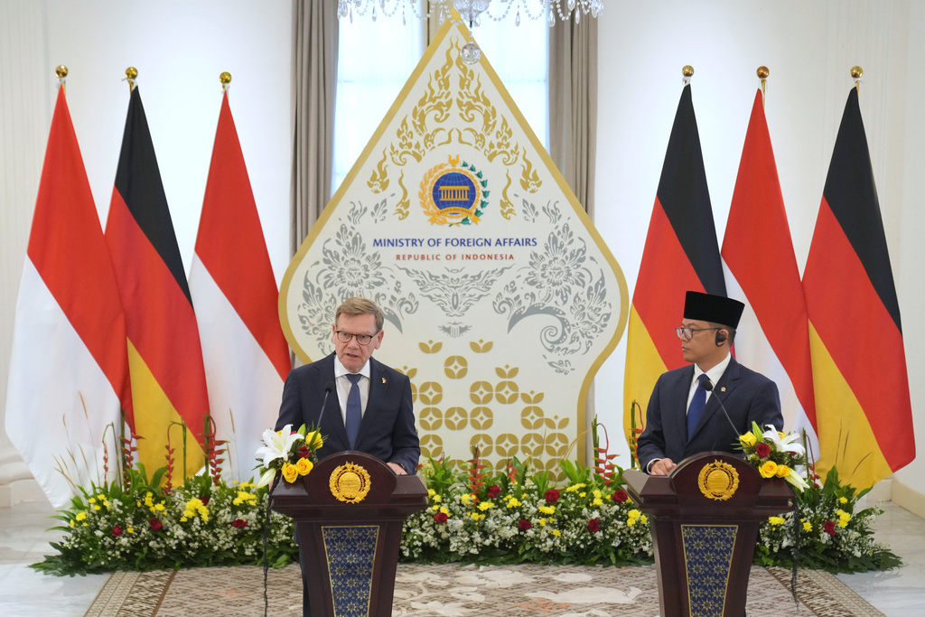 German Foreign Minister Johann Wadephul, left, speaks to the media as his Indonesian counterpart Sugiono listens during a press conference after their meeting in Jakarta, Indonesia, Wednesday, Aug. 20, 2025. (AP Photo/Dita Alangkara)