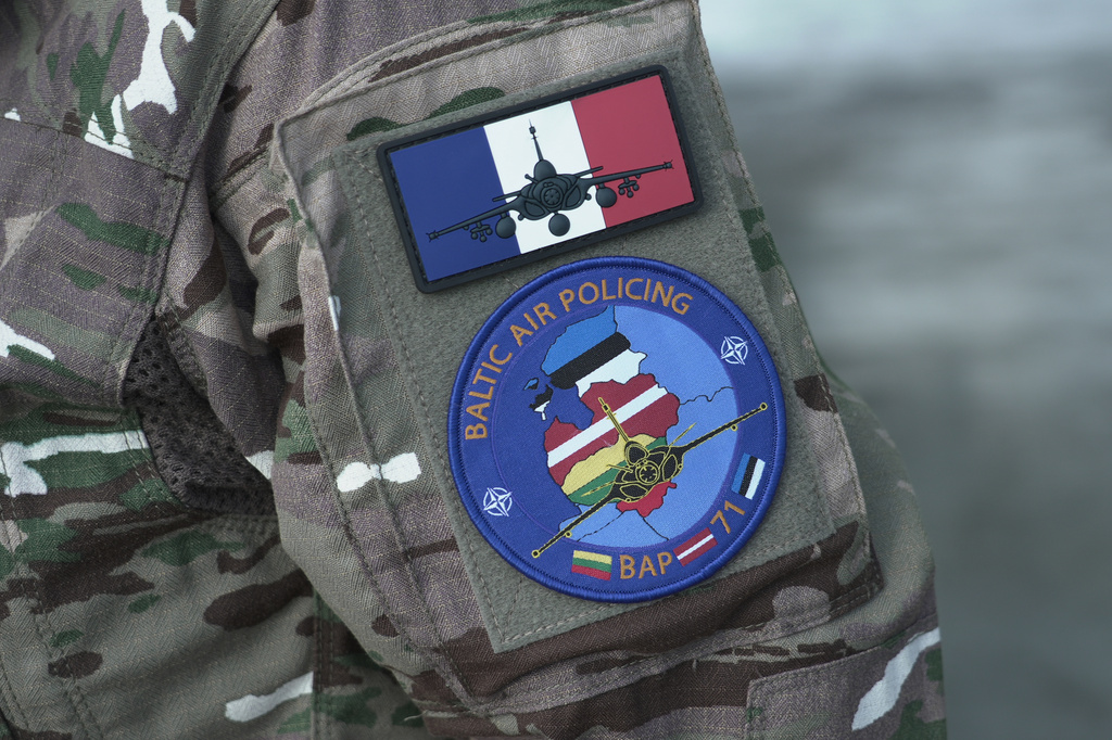A member of the French air wing of Rafale fighters jets deployed on a NATO air-policing mission at the Siauliai Air Base in Lithuania wears a mission badge on her arm on Sunday, April 19, 2026 (AP Photo/John Leicester).