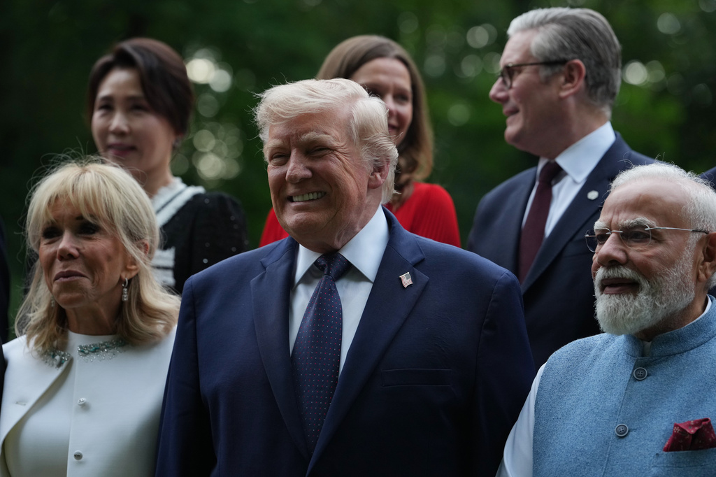 U.S. President Donald Trump poses with and first lady Brigitte Macron and India's Prime Minister Narenda Modi during a group photo of leaders at the G7 summit, Tuesday, June 16, 2026, in Evian-les-Bains, France. (AP Photo/Julia Demaree Nikhinson)