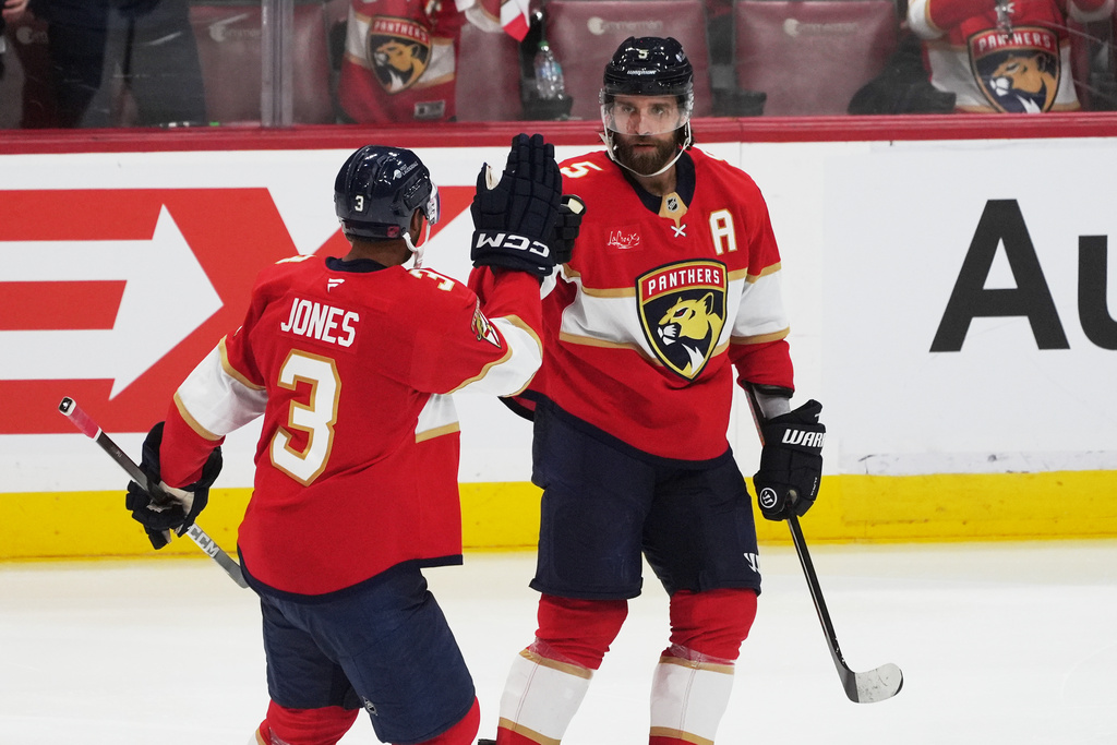 Florida Panthers defenseman Aaron Ekblad (5) celebrates his goal with defenseman Seth Jones (3) during the second period of an NHL hockey game against the Ottawa Senators, Saturday, Oct. 11, 2025, in Sunrise, Fla. (AP Photo/Marta Lavandier)