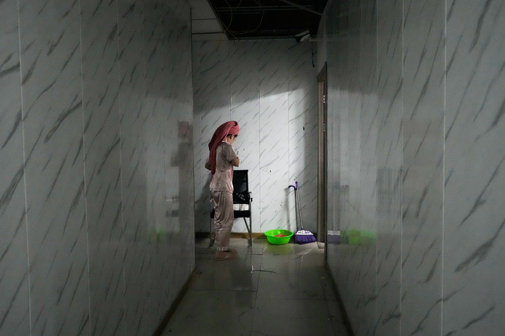 A rescued Indonesian scam worker walks inside the Presidential Anti-Organized Crime Commission temporary detention center, a former scam compound in Pasay, Philippines, Tuesday, June 3, 2025. (AP Photo/Aaron Favila)