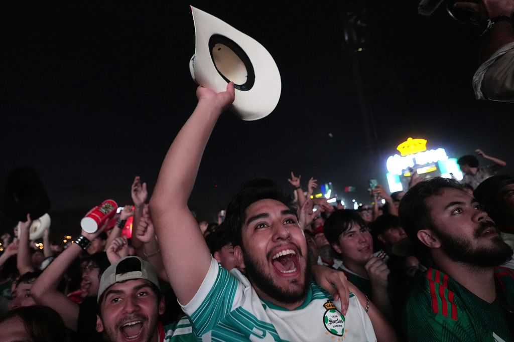 FILE - Fans celebrate after Mexico's Luis Romo scored during a World Cup soccer match between Mexico and South Korea at the FIFA Fan Zone in Monterrey, Mexico, June 18, 2026. (AP Photo/Dolores Ochoa, File)