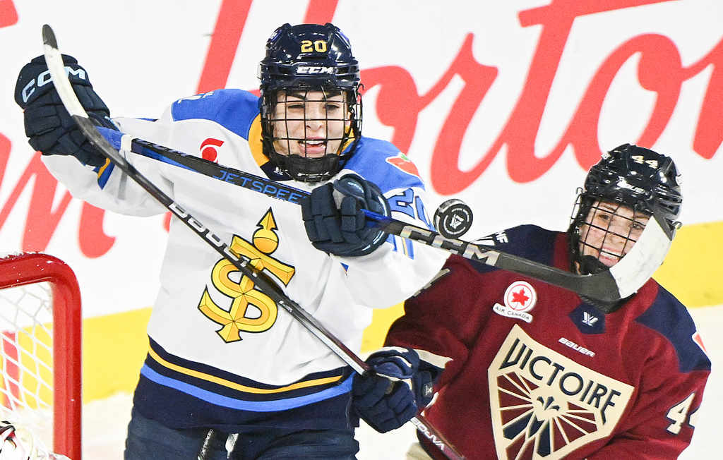 FILE - Toronto Sceptres' Sarah Nurse (20) and Montreal Victoire's Amanda Boulier (44) battle for the puck during the second period of a PWHL hockey game in Laval, Quebec, Jan. 30, 2025. (Graham Hughes/The Canadian Press via AP, File)