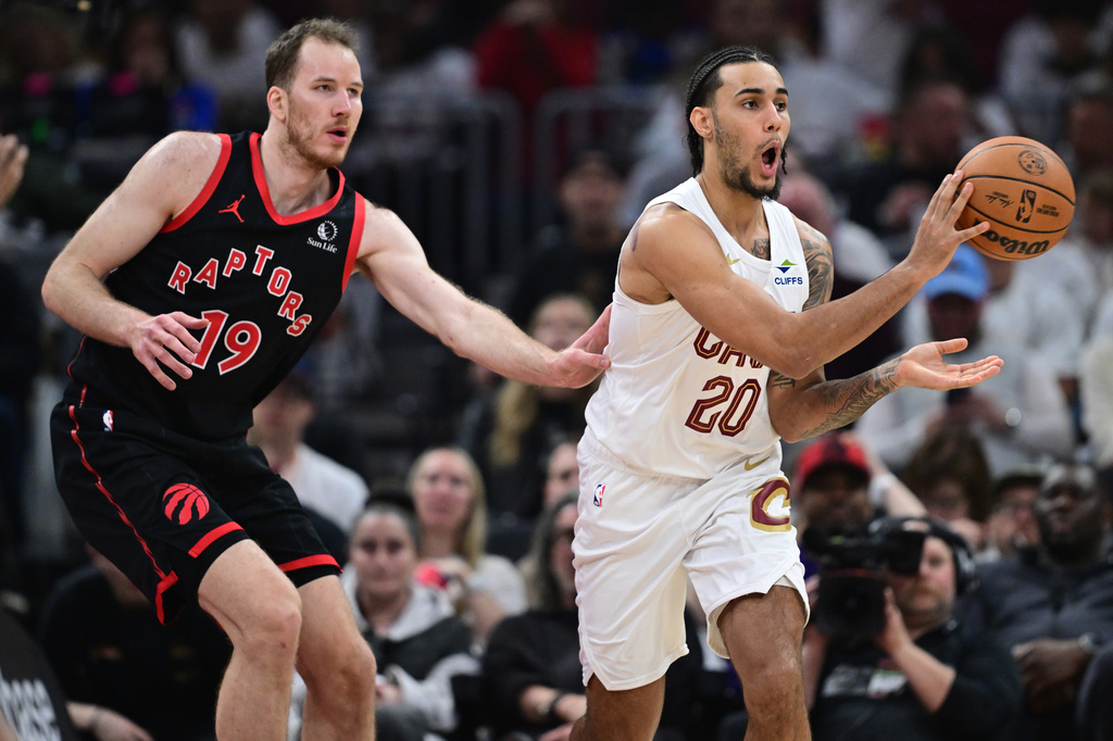 Cleveland Cavaliers guard Jaylon Tyson passes as Toronto Raptors center Jakob Poeltl, left, defends during the first half in Game 5 of a first-round NBA playoffs basketball series, Wednesday, April 29, 2026, in Cleveland. (AP Photo/David Dermer)