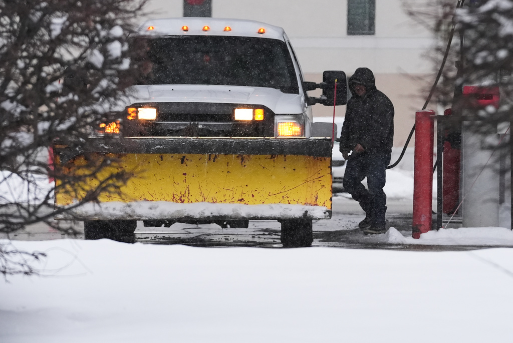A man fills up a vehicle's gas tank at a gas station in Buffalo Grove, Ill., Monday, Dec. 1, 2025. (AP Photo/Nam Y. Huh)