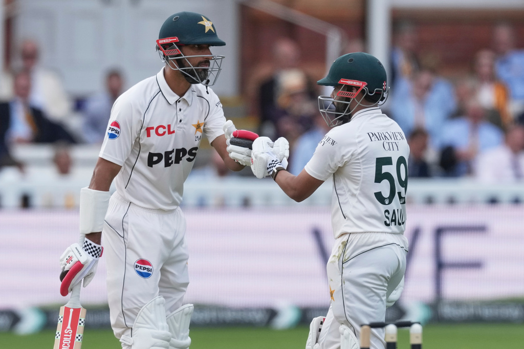 Pakistan's Shan Masood, left, and batting partner Saud Shakeel celebrate scoring runs on day four of the second cricket test match between England and Pakistan in London, Sunday, Aug. 30, 2026. (AP Photo/Dave Shopland)