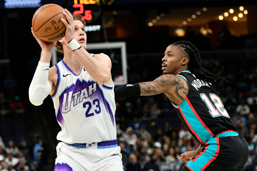 Utah Jazz forward Lauri Markkanen (23) handles the ball against Memphis Grizzlies guard Ja Morant (12) in the first half of an NBA basketball game Friday, Dec. 12, 2025, in Memphis, Tenn. (AP Photo/Brandon Dill)