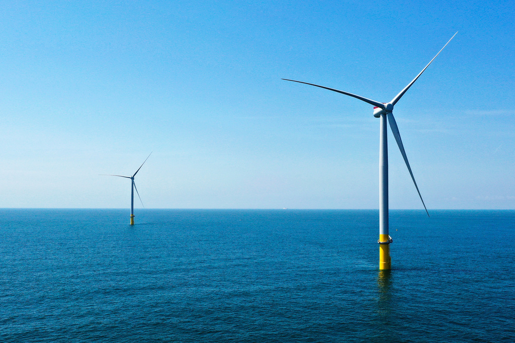 FILE - Two offshore wind turbines are seen off the coast of Virginia Beach, Va., on June 29, 2020. (AP Photo/Steve Helber, File)