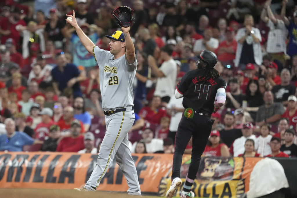 Milwaukee Brewers' Trevor Megill celebrates his team's win after the last out of the game is recorded in the ninth inning of a baseball game against the Cincinnati Reds, Friday, Aug. 15, 2025, in Cincinnati. (AP Photo/Kareem Elgazzar)