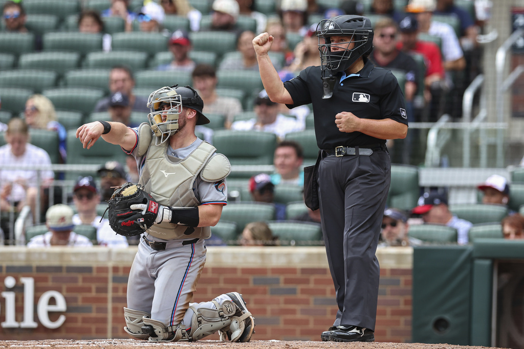 Home plate umpire Jen Pawol signals a strikeout in the third inning of a baseball game between the Miami Marlins and Atlanta Braves, Sunday, Aug. 10, 2025, in Atlanta. (AP Photo/Colin Hubbard)