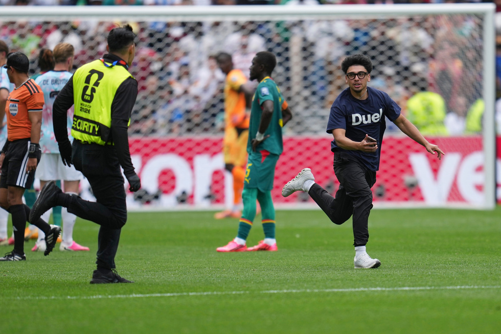A fan runs onto the pitch during the World Cup round of 32 soccer match between Belgium and Senegal in Seattle, Wednesday, July 1, 2026. (AP Photo/Abbie Parr)