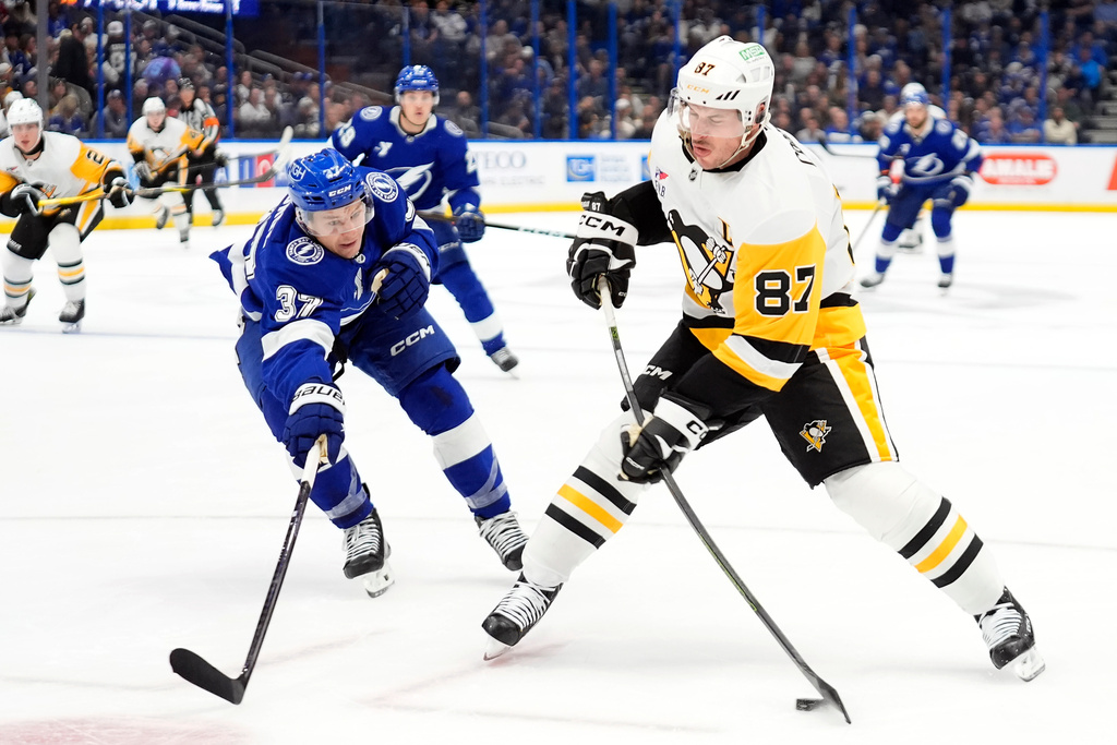 Pittsburgh Penguins center Sidney Crosby (87) shoots against Tampa Bay Lightning center Yanni Gourde (37) during the first period of an NHL hockey game Thursday, Dec. 4, 2025, in Tampa, Fla. (AP Photo/Chris O'Meara)