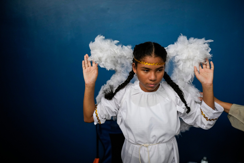 A devotee in an angel costume prepares for the Way of the Cross procession on Good Friday during Holy Week in Arraijan, Panama, Friday, April 3, 2026. (AP Photo/Matias Delacroix)