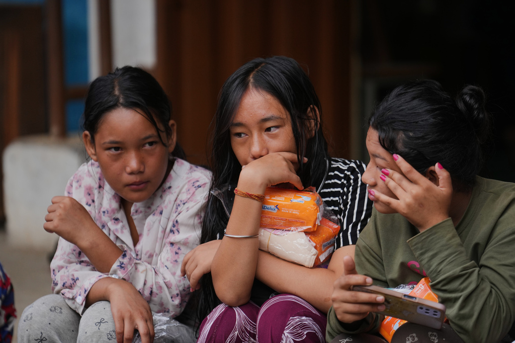 Displaced girls sit at a school converted into a temporary shelter for displaced residents in residents in Bidur, in Nepal's Nuwakot district, Tuesday, Sept. 1, 2026. (AP Photo/Rajesh Kumar Singh)