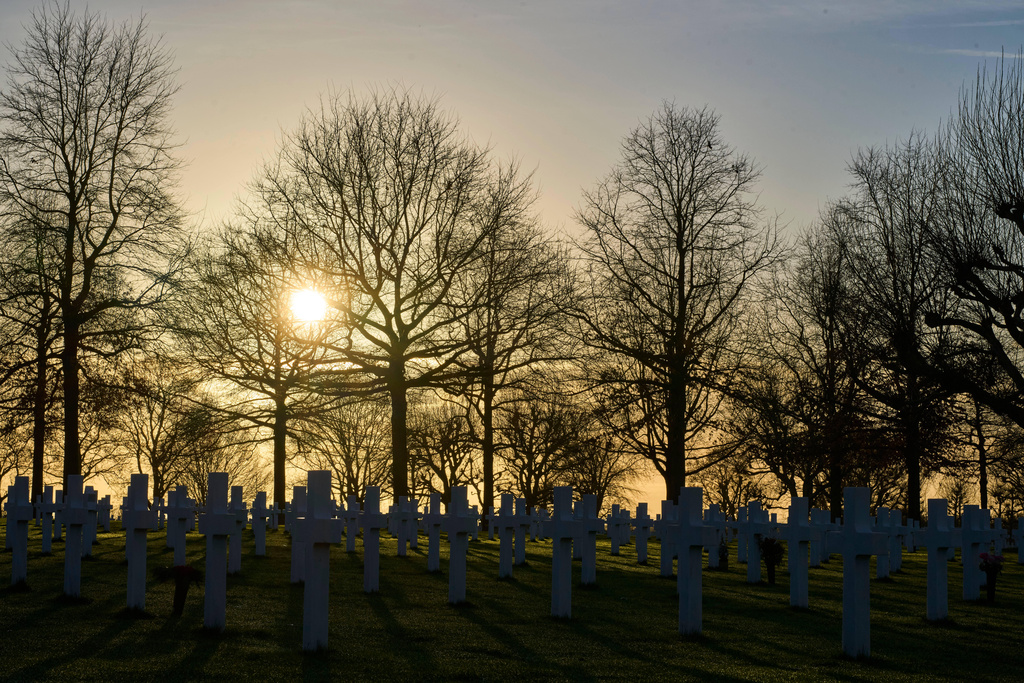 The sun sets over the graves of more than 8.300 WWII soldiers at the Netherlands American Cemetery in Margraten, Netherlands, Thursday, Dec. 11, 2025, where the American Battle Monuments Commission removed two displays honoring Black liberators from the visitors center. (AP Photo/Peter Dejong)