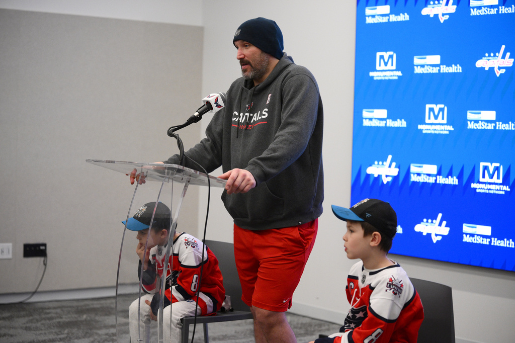 Washington Capitals left wing Alex Ovechkin, center, speaks at a news conference next to his sons, Ilya, left, and Sergei, right, after an NHL hockey game against the Pittsburgh Penguins, Sunday, April 12, 2026, in Washington. (AP Photo/Nick Wass)