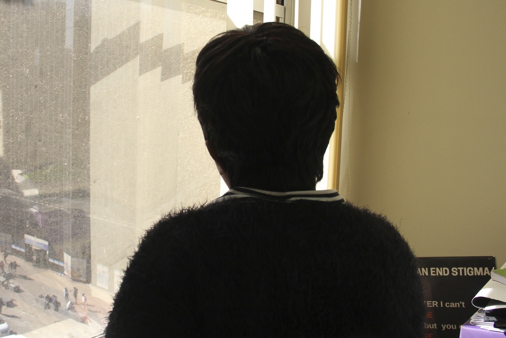A 37-year-old HIV-positive sex worker and mother of three, who requested anonymity, looks out her window in Johannesburg, South Africa, Monday, June 23, 2025. (AP Photo/Louise Dewast)