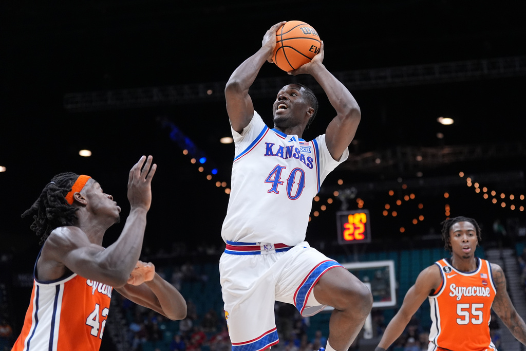 Kansas forward Flory Bidunga (40) shoots over Syracuse forward William Kyle III (42) during the first half of an NCAA college basketball game in the Players Era tournament Las Vegas, Tuesday, Nov. 25, 2025. (AP Photo/Eric Gay)
